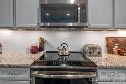 a kitchen with a stove and cabinets
