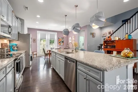 a kitchen with stainless steel appliances granite countertop a stove and refrigerator