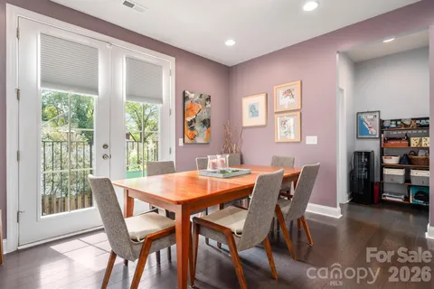 a dining room with furniture and wooden floor