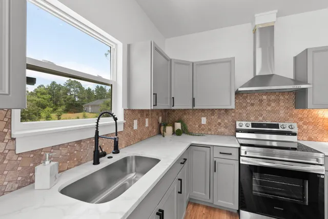 a kitchen that has a sink and a stove