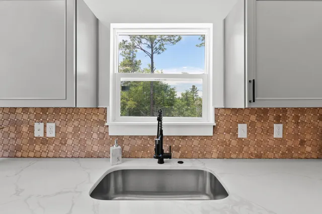 a kitchen with a sink and a window