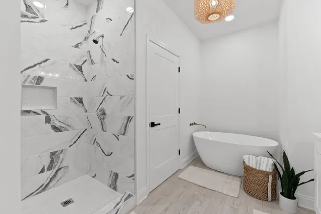 a bathroom with a sink and mirror with bathtub