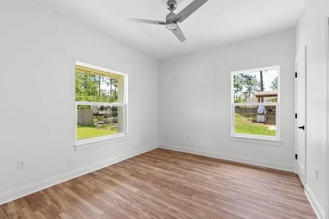 an empty room with windows and closet