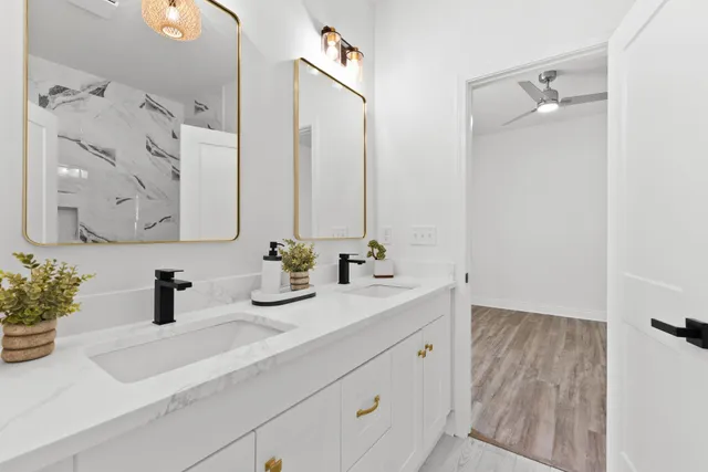 a bathroom with double vanity sink a mirror and shower