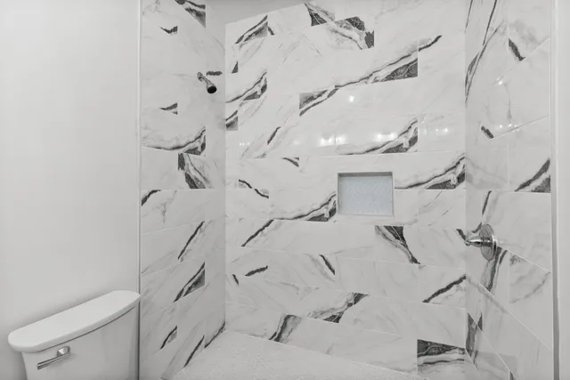 a bathroom with a bathtub and shower