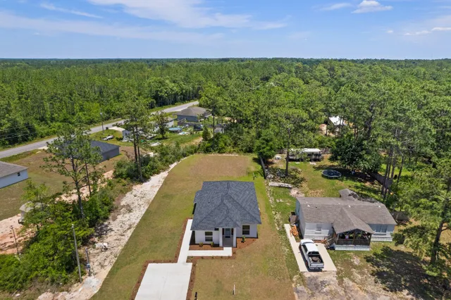 an aerial view of a house with a yard
