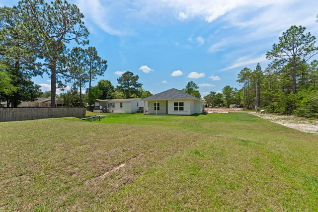 a front view of a house with a garden and yard