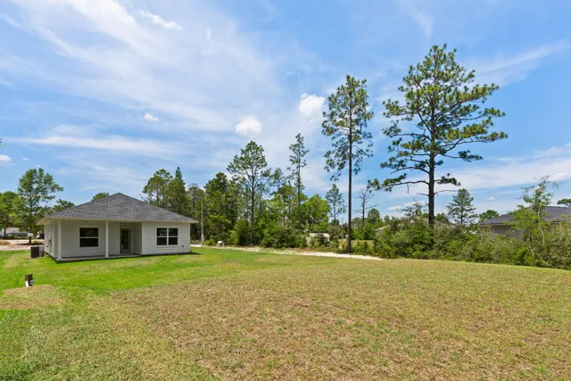 a view of a house with a yard and garage