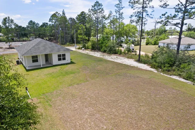a aerial view of a house with swimming pool and big yard