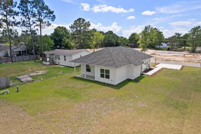 a view of a house with swimming pool and sitting area