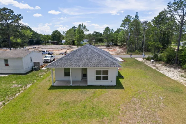 a view of a house with swimming pool and a yard