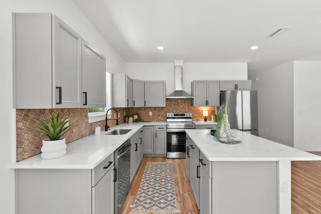 a kitchen with a sink a stove and cabinets