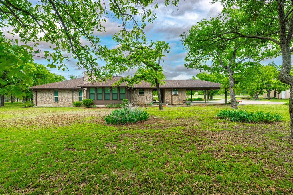 970 Live Oak Road Santo, TX 76472 - Photo 5 of 40 a front view of a house with a yard