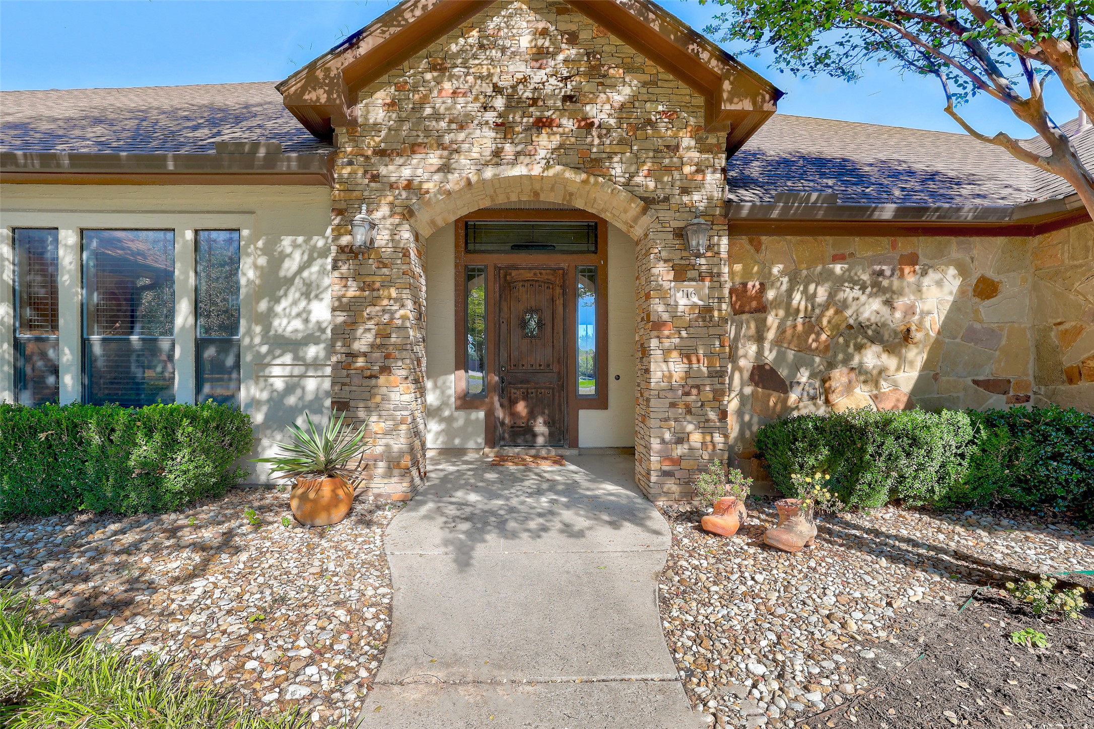 Undisclosed Address Georgetown, TX 78633 - Photo 7 of 39 Entrance to property with stone siding, a shingled roof, and brick siding