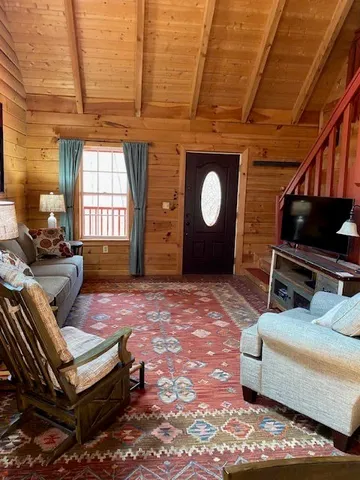 a bedroom with a bed and a lamp on dresser