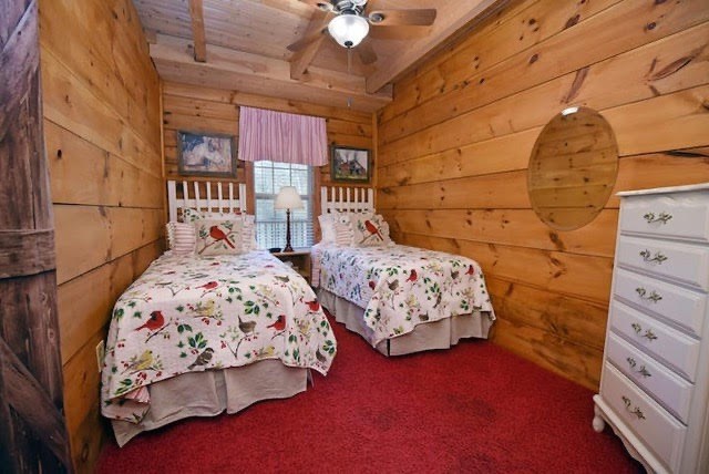 360 Johnson Cove Road Copperhill, TN 37317 - Photo 22 of 56 a bedroom with two beds and a chandelier