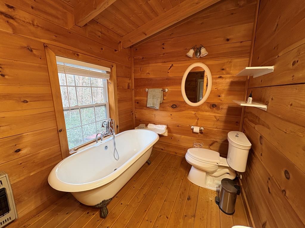 360 Johnson Cove Road Copperhill, TN 37317 - Photo 41 of 56 a bathroom with a sink mirror bathtub and toilet