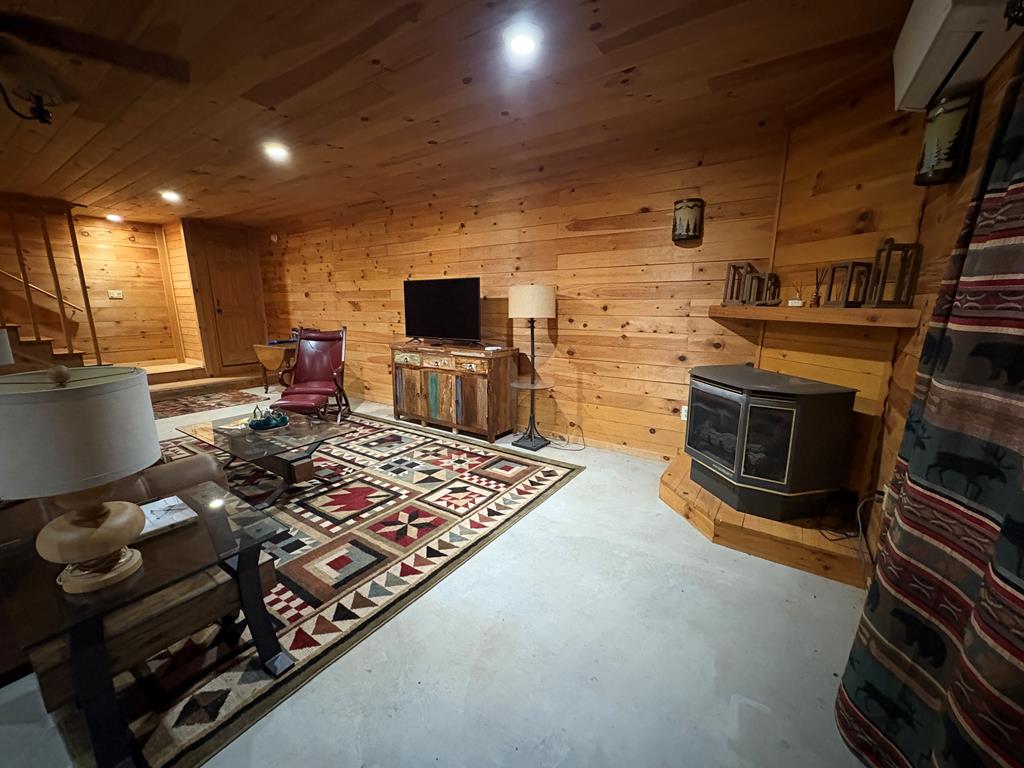 360 Johnson Cove Road Copperhill, TN 37317 - Photo 48 of 56 a living room with furniture a flat screen tv and a fireplace