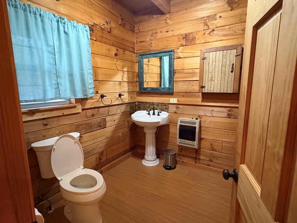 360 Johnson Cove Road Copperhill, TN 37317 - Photo 54 of 56 a bathroom with a toilet sink and mirror