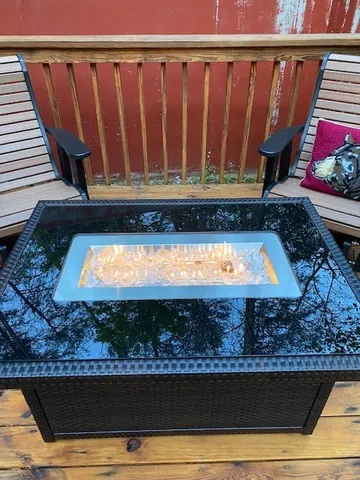 a living room with furniture gym equipment and a window