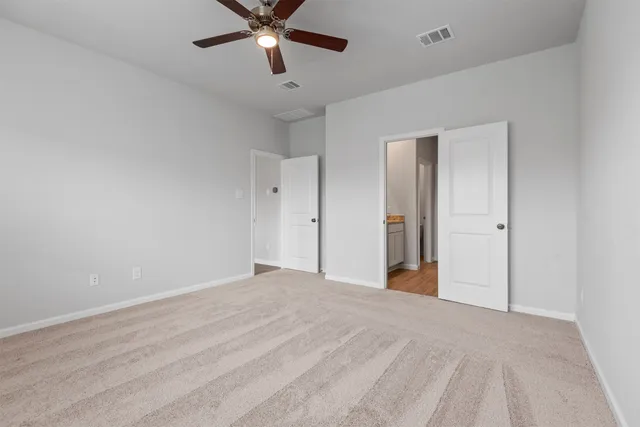 a view of a big room with wooden floor and windows in a room