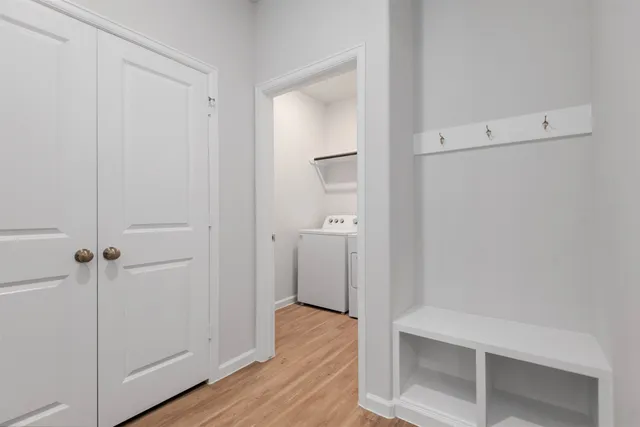 a view of a hallway with wooden floor