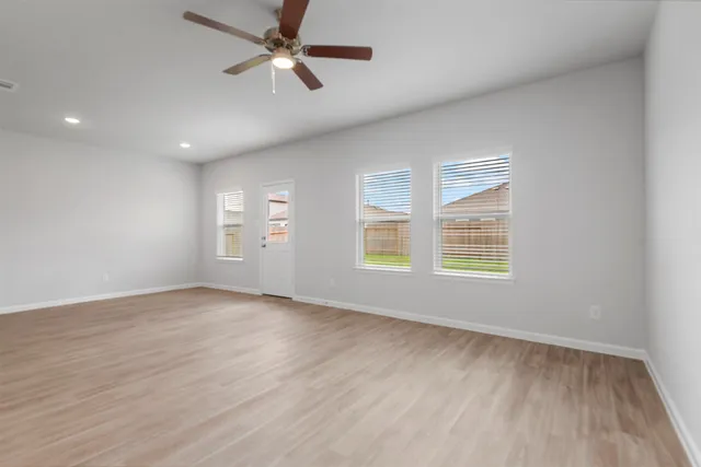 wooden floor in an empty room with a window