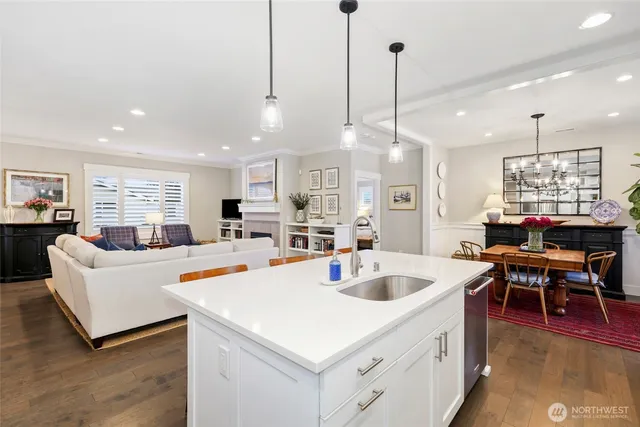 a view of kitchen island sink and living room