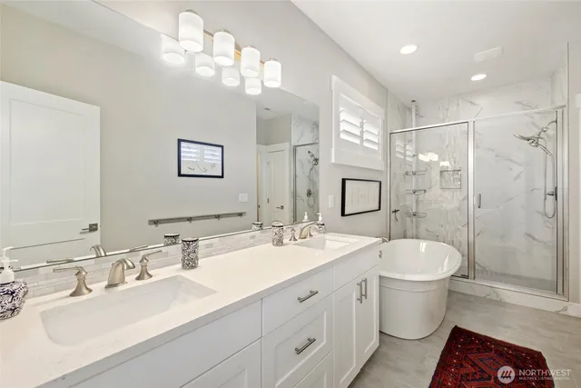 a bathroom with a double vanity sink mirror double and shower