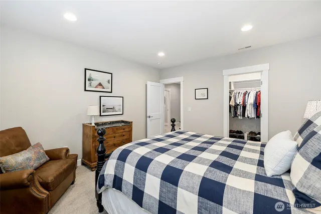 a bedroom with a bed and a couch