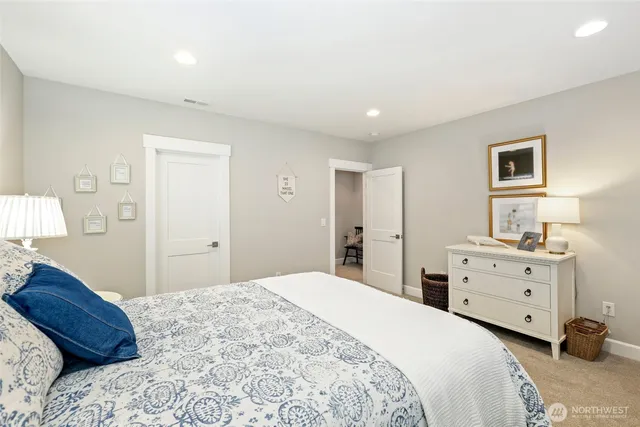 a bedroom with a bed and a dresser