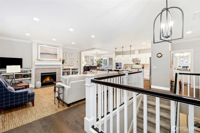a view of a livingroom with fireplace kitchen view and living room view