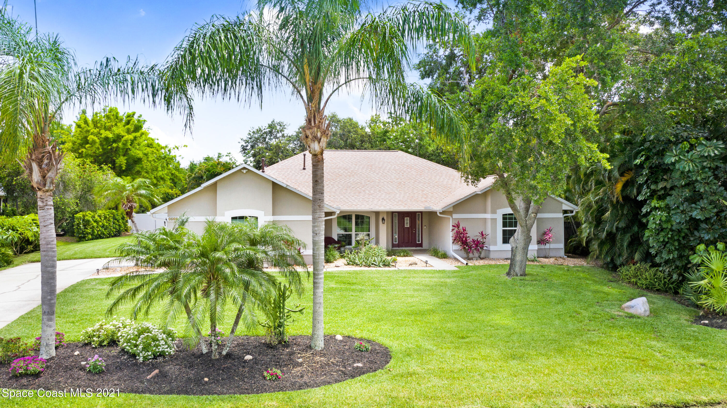 4689 Canard Road Melbourne, FL 32934 - Photo 1 of 49 a front view of a house with garden