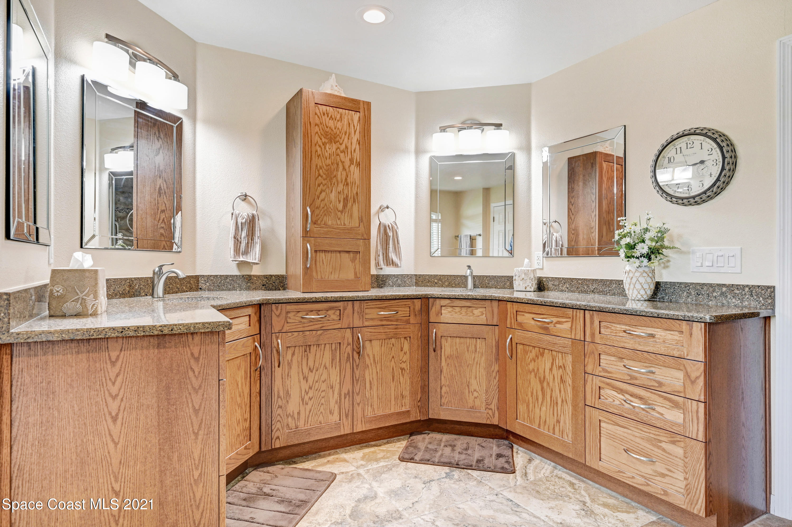 4689 Canard Road Melbourne, FL 32934 - Photo 17 of 49 a spacious bathroom with a granite countertop sink and a mirror