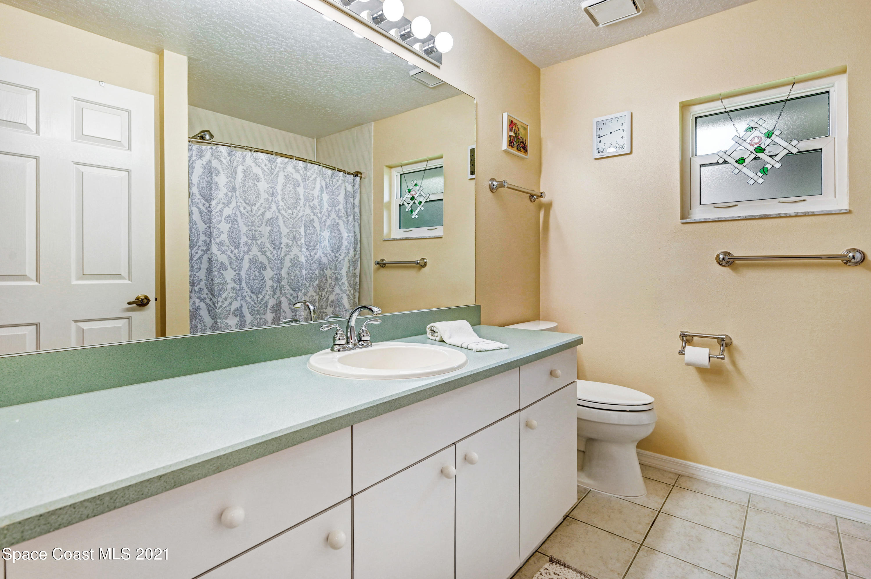 4689 Canard Road Melbourne, FL 32934 - Photo 30 of 49 a bathroom with a sink and a mirror