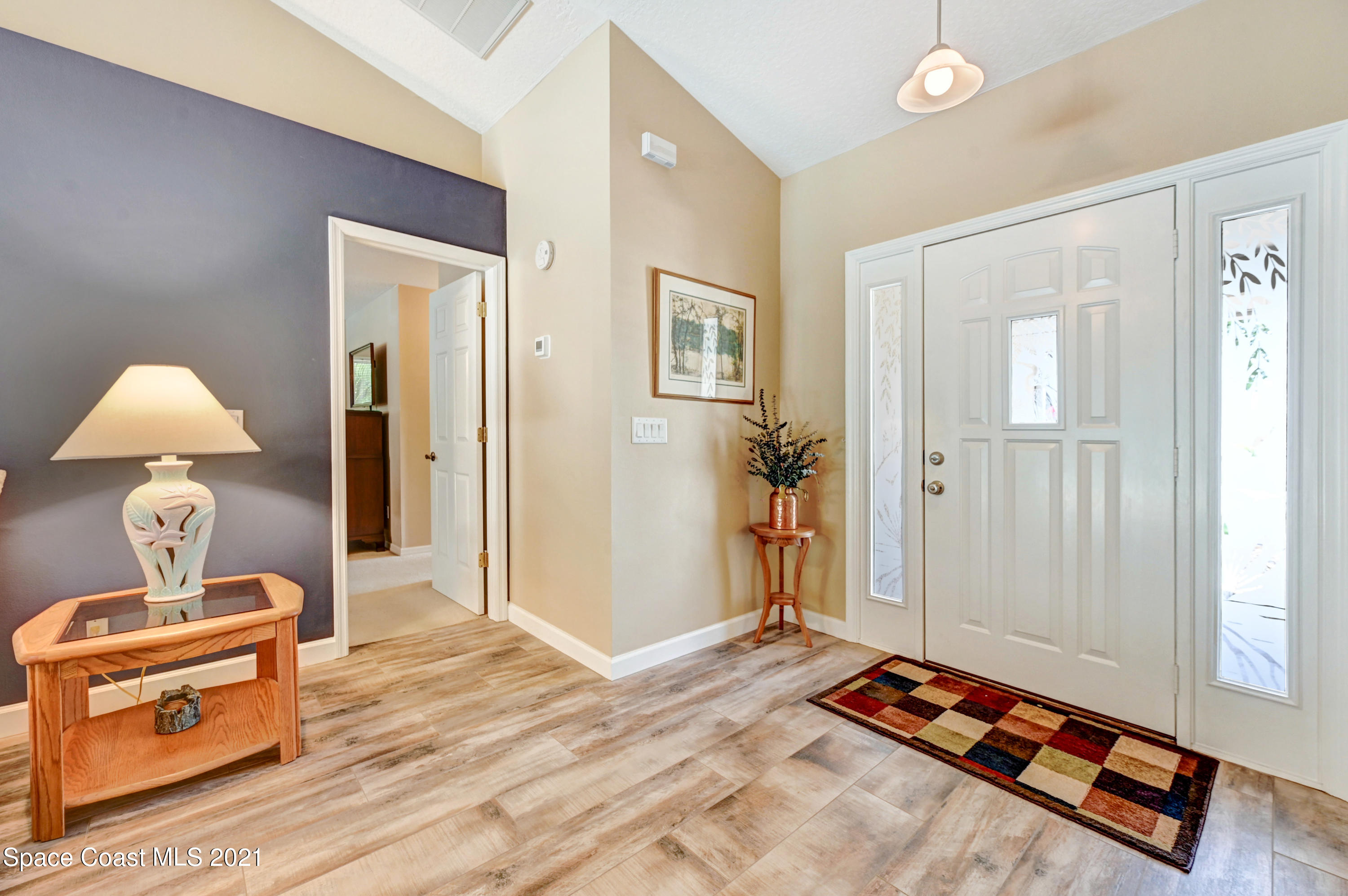 4689 Canard Road Melbourne, FL 32934 - Photo 4 of 49 a bedroom with a bed and a dresser