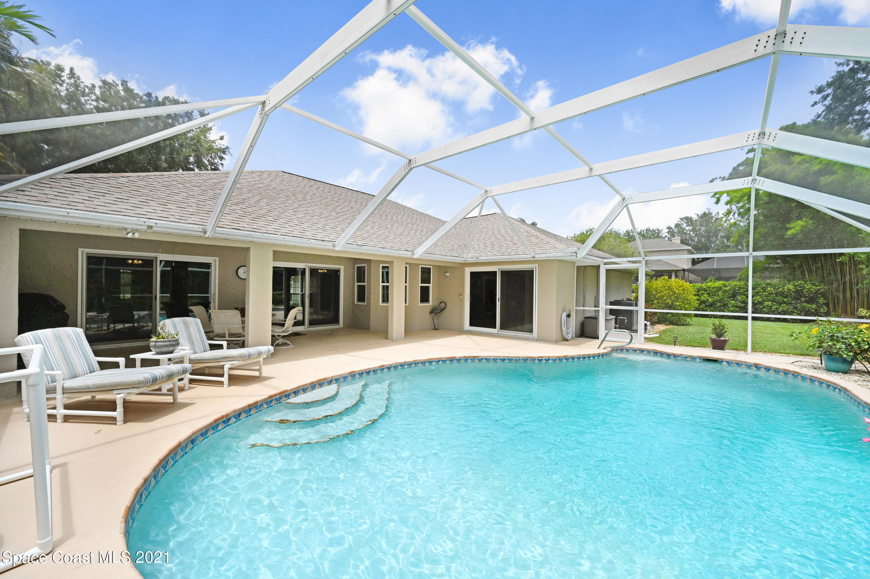 4689 Canard Road Melbourne, FL 32934 - Photo 35 of 49 a view of a house with backyard sitting area and porch