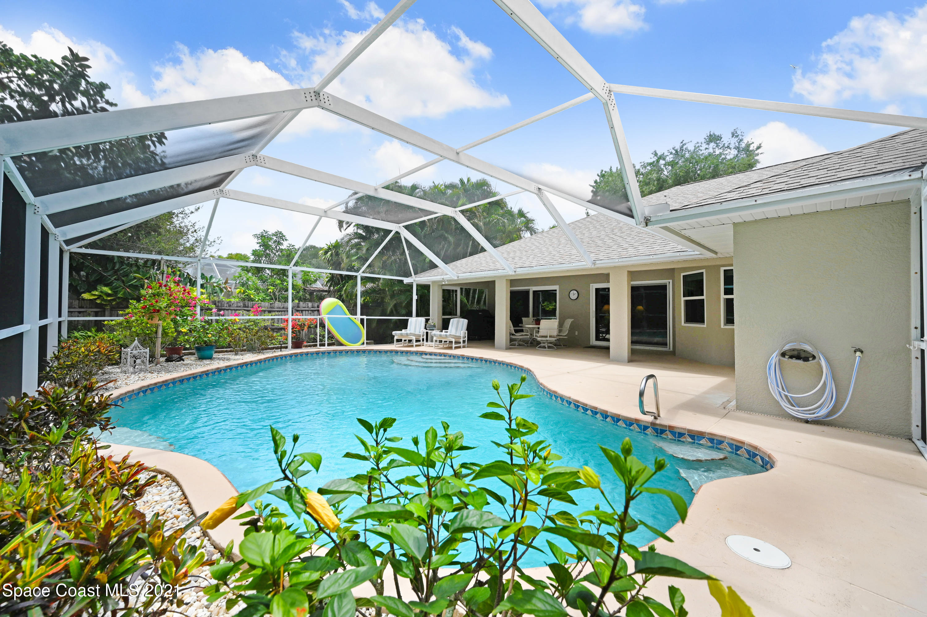 4689 Canard Road Melbourne, FL 32934 - Photo 36 of 49 a view of a house with pool and garden
