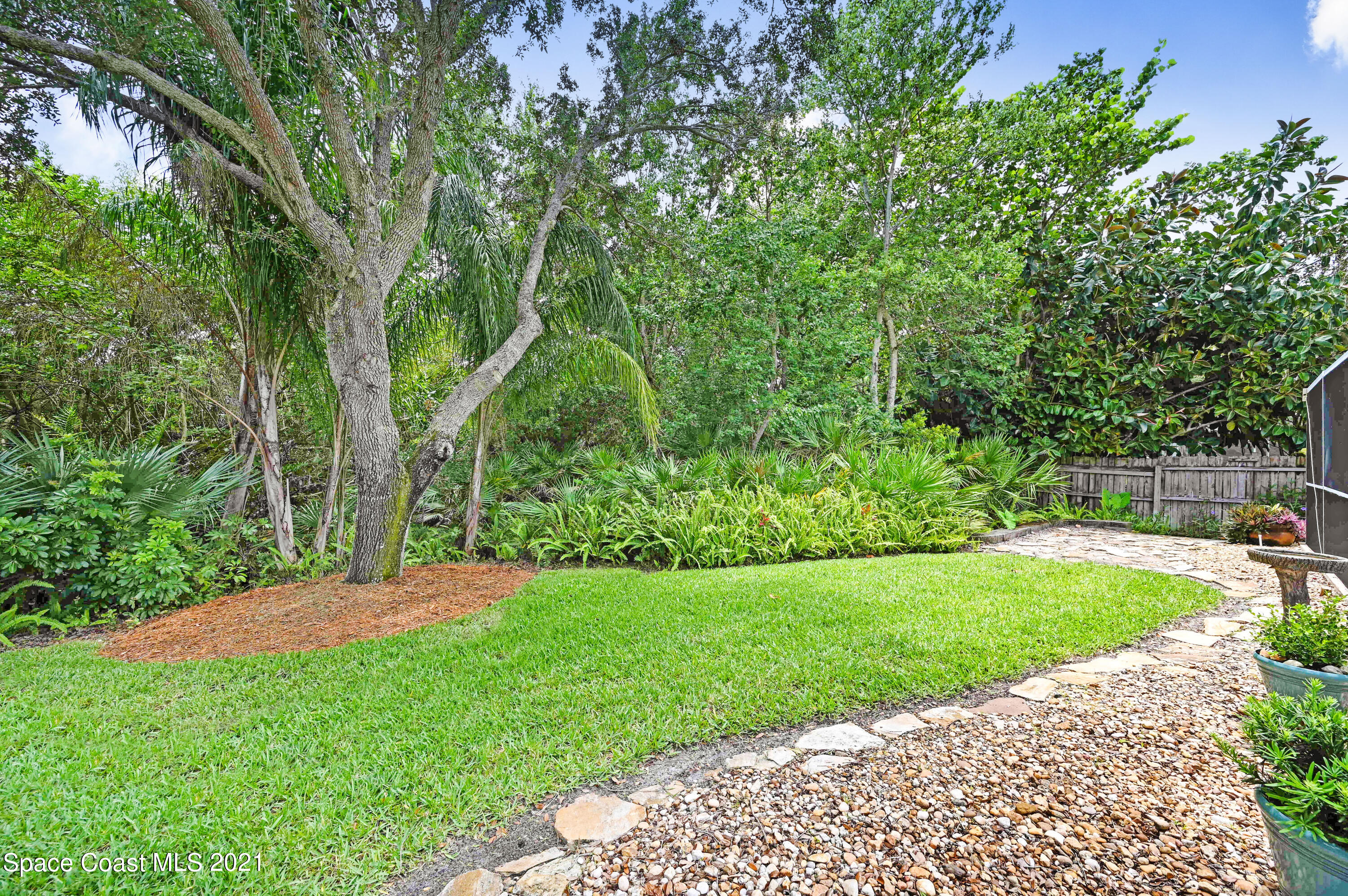 4689 Canard Road Melbourne, FL 32934 - Photo 39 of 49 a view of a backyard with a garden