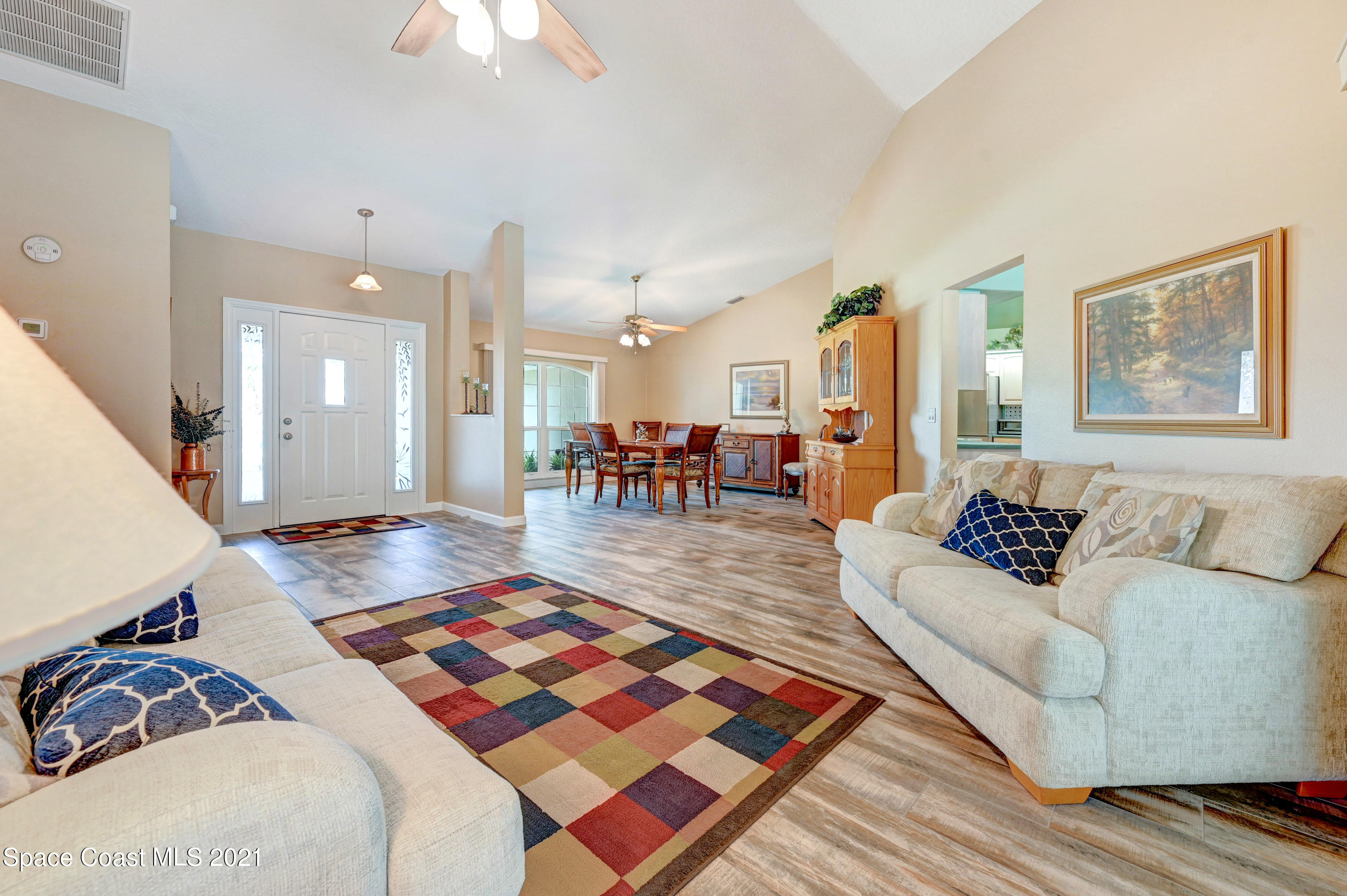 4689 Canard Road Melbourne, FL 32934 - Photo 7 of 49 a living room with furniture and a dining table