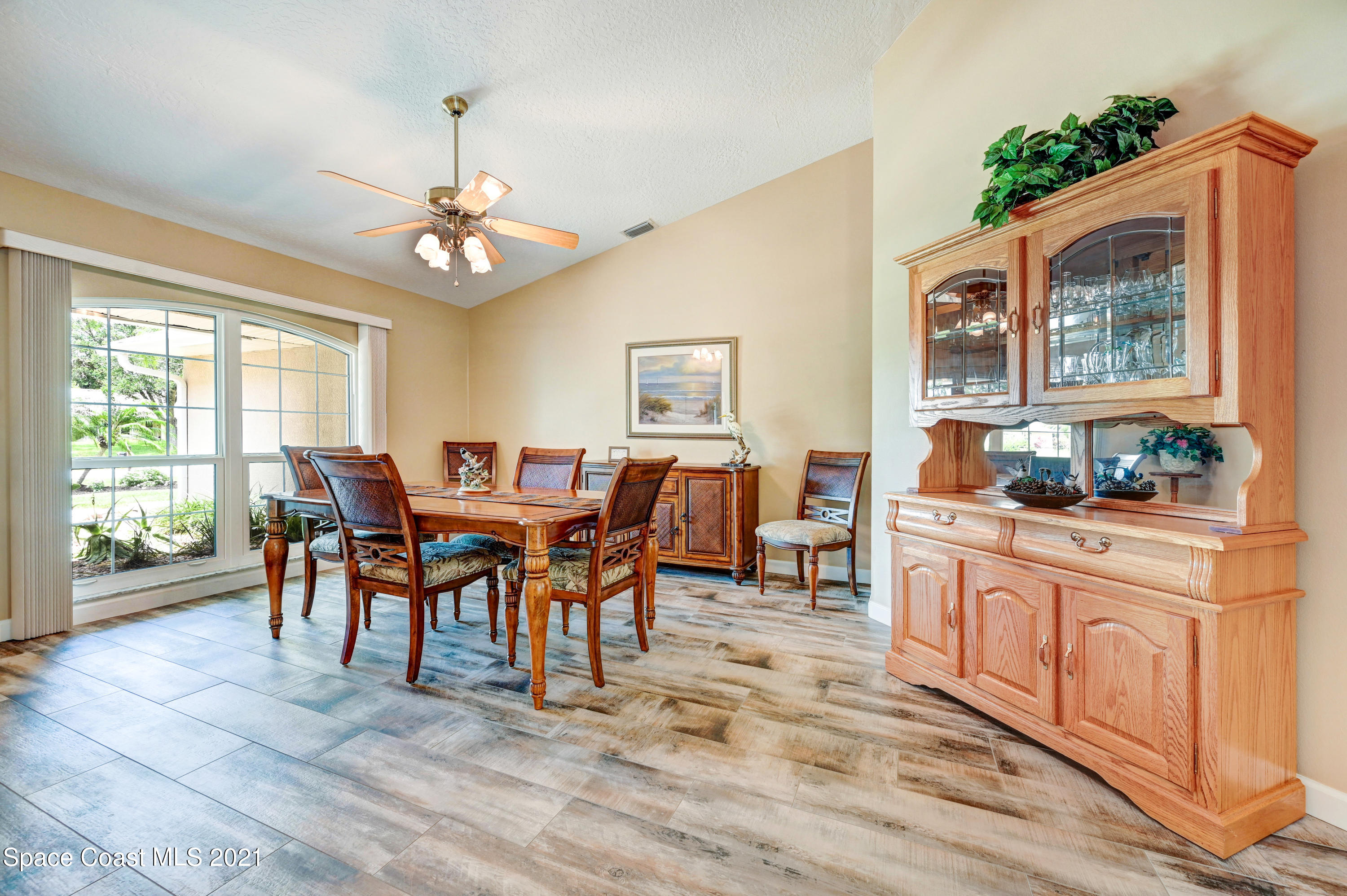 4689 Canard Road Melbourne, FL 32934 - Photo 10 of 49 a view of a dining room with furniture window and wooden floor