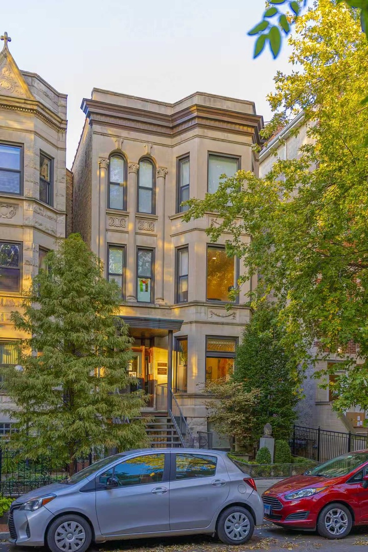 712 West Briar Place Chicago, IL 60657 - Photo 1 of 9 a front view of a house with parking area