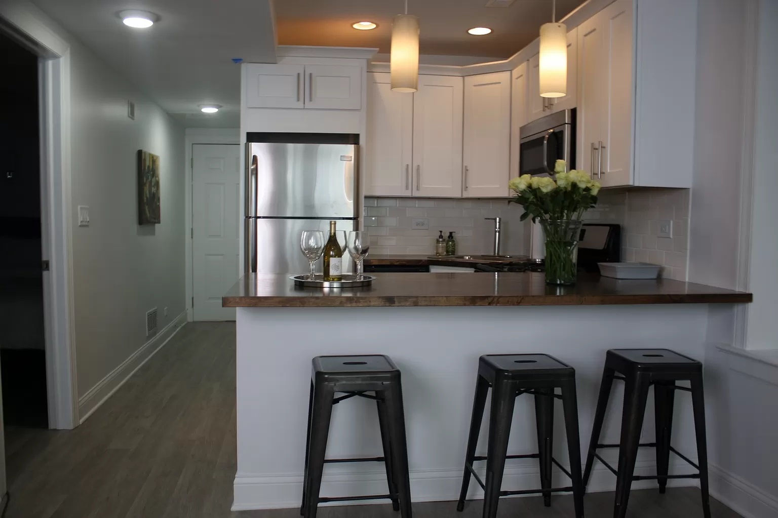 712 West Briar Place Chicago, IL 60657 - Photo 3 of 9 a kitchen with stainless steel appliances a sink a refrigerator a stove a microwave and cabinets