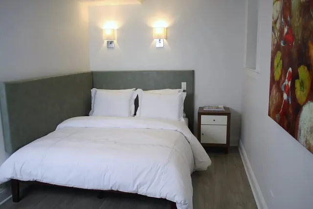 a bedroom with a bed and a night stand