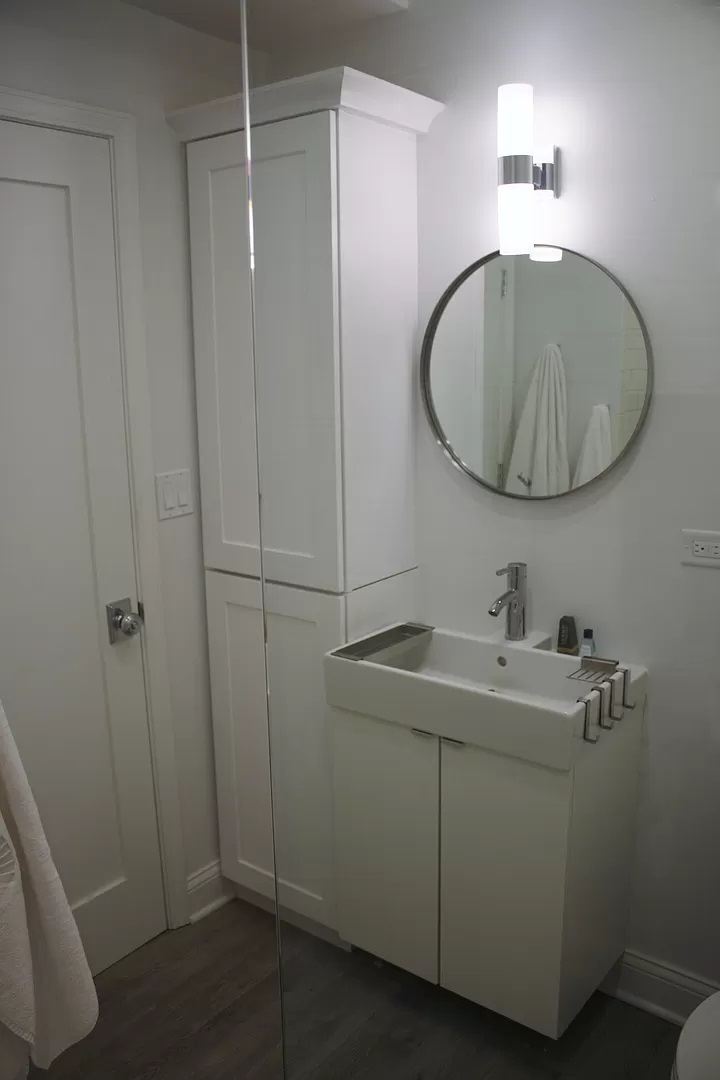 712 West Briar Place Chicago, IL 60657 - Photo 5 of 9 a bathroom with a sink and mirror