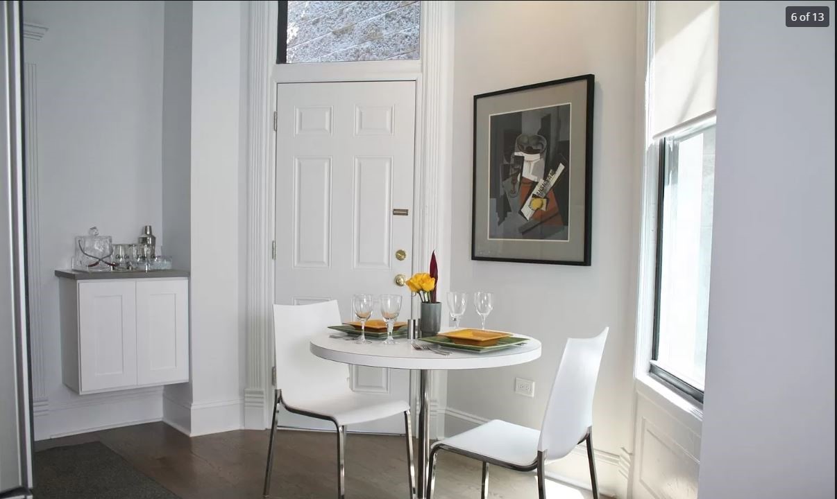 712 West Briar Place Chicago, IL 60657 - Photo 7 of 9 a view of a dining room with furniture and wooden floor
