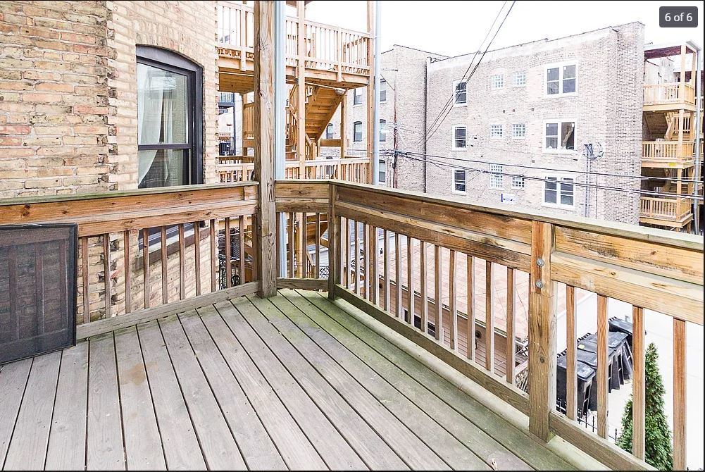 712 West Briar Place Chicago, IL 60657 - Photo 8 of 9 a view of a balcony with wooden floor