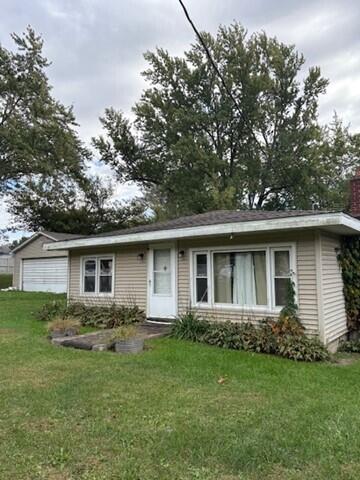 a front view of house with yard and green space