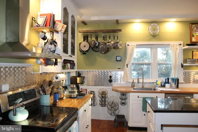 a dining room with furniture a chandelier and window
