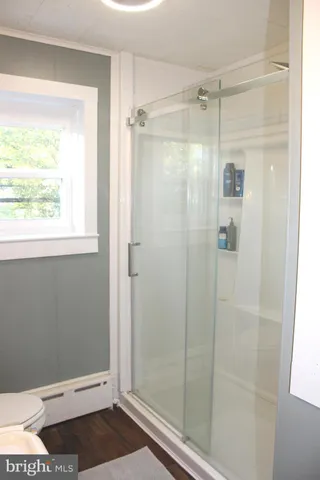 a bedroom with a bed dresser and a window